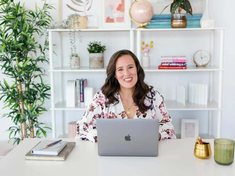 julie giovannetti with living in love coaching behind desk with laptop